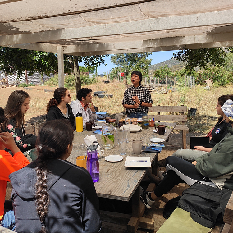 person speaking to a group outside